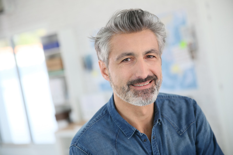 Portrait of smiling mature teacher in class